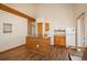 Compact kitchen featuring wood cabinetry, a small island, and a breakfast bar next to a refrigerator at 8853 N Awl Rd, Parker, CO 80138