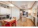 Charming kitchen with white cabinets, modern appliances, and a breakfast table with red chairs at 8853 N Awl Rd, Parker, CO 80138