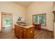 Rustic kitchen with wood island, breakfast table, and backyard view at 8853 N Awl Rd, Parker, CO 80138