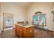 Kitchen area with wood-look flooring, a wooden island, and a small table with chairs by the window at 8853 N Awl Rd, Parker, CO 80138