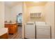 Convenient laundry area off the kitchen, featuring modern appliances, wood cabinets and shelf storage at 8853 N Awl Rd, Parker, CO 80138