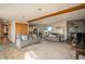 Spacious living room features a stone fireplace, wood beams, and neutral carpeting at 8853 N Awl Rd, Parker, CO 80138