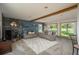 Spacious living room boasting a stone fireplace, comfortable seating, and abundant natural light through large windows at 8853 N Awl Rd, Parker, CO 80138