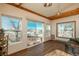 Bright living room with wood beam ceilings, hardwood floors, and view of patio at 8853 N Awl Rd, Parker, CO 80138
