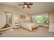 Inviting main bedroom featuring a window seat and large window with a view of mature trees at 8853 N Awl Rd, Parker, CO 80138