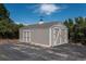 An exterior shot of the outbuilding with a weather vane on the roof in a tree filled lot at 8853 N Awl Rd, Parker, CO 80138