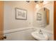Charming powder room features a pedestal sink, decorative mirror, and wainscoting at 8853 N Awl Rd, Parker, CO 80138