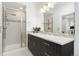 Modern bathroom boasts a walk-in shower and dark wood vanity at 6860 E Lowry Blvd, Denver, CO 80230