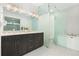 Contemporary bathroom with double vanity and glass enclosed shower at 6860 E Lowry Blvd, Denver, CO 80230