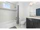 Simple bathroom with shower/tub combo and dark vanity at 6860 E Lowry Blvd, Denver, CO 80230