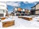 Modern townhomes with snowy front yards and garden boxes at 6860 E Lowry Blvd, Denver, CO 80230