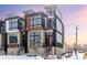 Modern three story home with snowy landscaping at 6860 E Lowry Blvd, Denver, CO 80230