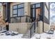 Modern home's exterior with snowy front steps at 6860 E Lowry Blvd, Denver, CO 80230