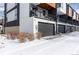 Attached garage with ample space and snow covered driveway at 6860 E Lowry Blvd, Denver, CO 80230