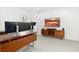 Bright home office features wood desk, large monitor setup, and mid-century modern credenza at 6860 E Lowry Blvd, Denver, CO 80230