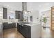 Modern kitchen with stainless steel appliances and island with seating at 6860 E Lowry Blvd, Denver, CO 80230