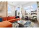 Bright living room with orange couch and city views at 6860 E Lowry Blvd, Denver, CO 80230