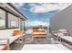 Snow covered rooftop deck with modern furniture and city views at 6860 E Lowry Blvd, Denver, CO 80230