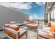 Spacious rooftop deck with orange couches and chairs, perfect for entertaining at 6860 E Lowry Blvd, Denver, CO 80230