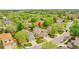 Suburban home with a two-car garage, mature trees, and a well-maintained lawn at 10653 W Parkhill Dr, Littleton, CO 80127