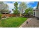 Lush backyard with a spacious deck, perfect for outdoor gatherings and relaxation at 10653 W Parkhill Dr, Littleton, CO 80127