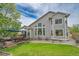 Expansive backyard with a deck, lush lawn, and exterior windows at 10653 W Parkhill Dr, Littleton, CO 80127