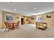 Spacious basement area with seating, table, cabinet, and windows for natural light at 10653 W Parkhill Dr, Littleton, CO 80127