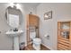 Charming powder room features pedestal sink, accent cabinet, and tile floors at 10653 W Parkhill Dr, Littleton, CO 80127