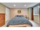Bedroom with a well lit and cozy setting, and a large bed at 10653 W Parkhill Dr, Littleton, CO 80127