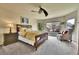 Comfortable bedroom with large window, ceiling fan, side table and furniture at 10653 W Parkhill Dr, Littleton, CO 80127