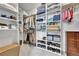 Organized walk-in closet with custom shelving, rods, and ample storage space for clothing, shoes, and accessories at 10653 W Parkhill Dr, Littleton, CO 80127