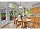 Bright dining room with tile floors, pendant lighting, and doors leading to an outdoor deck at 10653 W Parkhill Dr, Littleton, CO 80127