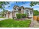 Charming two-story home with a well-manicured lawn, beautiful brick accents and a 3-car garage at 10653 W Parkhill Dr, Littleton, CO 80127