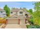 Charming two-story home featuring a three car garage, brick accents and a well maintained lawn at 10653 W Parkhill Dr, Littleton, CO 80127