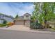 Charming home with a manicured lawn and a three-car garage at 10653 W Parkhill Dr, Littleton, CO 80127