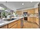 Open kitchen with stainless appliances, center island, modern counters, and tile floors at 10653 W Parkhill Dr, Littleton, CO 80127