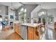 Open concept kitchen with modern appliances, a large island and great view of the living room fireplace at 10653 W Parkhill Dr, Littleton, CO 80127