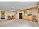 Spacious living room with dining table and wooden cabinet with glass doors at 10653 W Parkhill Dr, Littleton, CO 80127