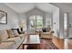 Bright living room with hardwood floors, plantation shutters and a large arched window at 10653 W Parkhill Dr, Littleton, CO 80127