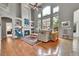 Open concept living room boasts a soaring ceiling, fireplace, and large windows with tons of natural light at 10653 W Parkhill Dr, Littleton, CO 80127