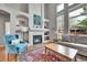 Elegant living room featuring a fireplace, high ceilings and an arched window overlooking the backyard at 10653 W Parkhill Dr, Littleton, CO 80127