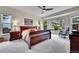 Sunlit main bedroom featuring a sitting area, ceiling fan, neutral colors, and comfortable layout at 10653 W Parkhill Dr, Littleton, CO 80127