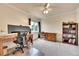 Bright home office with modern desk, bookcase, chair, and a large window at 10653 W Parkhill Dr, Littleton, CO 80127