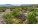 Aerial view of a home featuring a large lawn, patio, and mature trees at 12992 W Jewell Cir, Lakewood, CO 80228