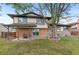 A lovely home with a brick patio and a large tree in the backyard at 12992 W Jewell Cir, Lakewood, CO 80228