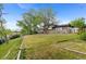 Spacious backyard with mature trees, and a covered patio area at 12992 W Jewell Cir, Lakewood, CO 80228