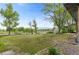 Expansive backyard with mature trees and lush green grass at 12992 W Jewell Cir, Lakewood, CO 80228