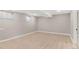 Open basement living area featuring laminate flooring and natural light from above-ground windows at 12992 W Jewell Cir, Lakewood, CO 80228