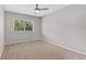 Comfortable bedroom with a ceiling fan, neutral walls, carpet flooring and natural light streaming in from the window at 12992 W Jewell Cir, Lakewood, CO 80228