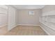 Bright bedroom with plush carpet, built in storage, and a window letting in lots of light at 12992 W Jewell Cir, Lakewood, CO 80228